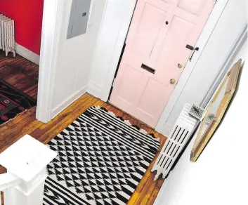  ??  ?? Painting the door millennial pink adds a touch of whimsy to the foyer, while a gold-framed octagonal mirror and patterned rug bring the space together. Total budget: $100.