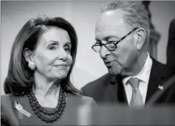  ?? ASSOCIATED PRESS ?? SENATE MINORITY LEADER SEN. CHUCK SCHUMER OF NEW YORK (RIGHT) and House Minority Leader Nancy Pelosi of California speak together during a news conference on Capitol Hill in Washington on Wednesday after the Senate passed a resolution to reverse the...