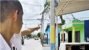 ?? JOHN ROBLEDO ?? Un habitante del barrio Los Olivos señala un poste de energía de la calle 109, donde varios cables se enredan y preocupan a diario a la comunidad.