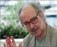  ?? LAURENT REBOURS — THE ASSOCIATED PRESS FILE ?? In this file photo dated Tuesday Swiss director Jean Luc Godard waves during a photo call at the festival palace in Cannes, France. The 87-year-old reclusive iconoclast director Jean-Luc Godard attended his Cannes Film Festival press conference...