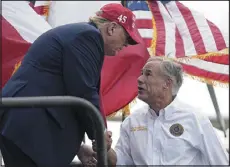  ?? ERIC GAY — THE ASSOCIATED PRESS ?? Former President Donald Trump, left, shakes hands with Texas Gov. Greg Abbott after he received Abbott’s endorsemen­t at the South Texas Internatio­nal Airport on Sunday in Edinburg, Texas.