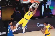  ?? MARK J. TERRILL/ASSOCIATED PRESS ?? LeBron James (23) slams home two points during the Lakers’ rout of Denver in Game 1 of the Western Conference finals on Friday night.