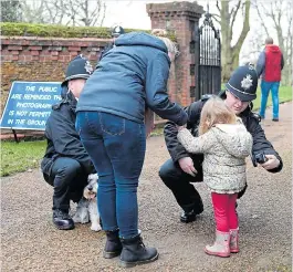  ??  ?? Well-wishers pass through police security checks at Sandringha­m