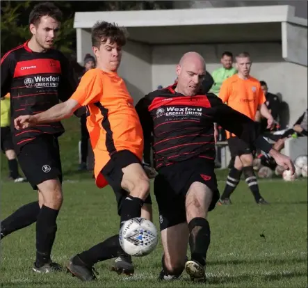  ??  ?? Sam O’Neill of Wexford Bohs and Colin Redmond of Bridge Rovers battle for the ball during their Premier Division match.