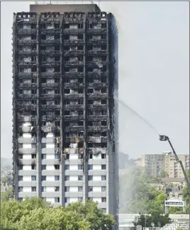  ?? AP PHOTO ?? Firefighte­rs spray water onto Grenfell Tower in London on June 14. The number of people killed or presumed dead in the high-rise fire has inched up to 80, but the final death toll may not be known for months, British police said yesterday.