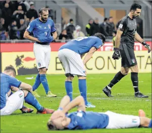  ?? AP PHOTO ?? Italian players react to their eliminatio­n at the end of the World Cup qualifying play-off second leg soccer match between Italy and Sweden, at the Milan San Siro stadium, Italy, Monday.