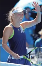  ?? DITA ALANGKARA/AP ?? Caroline Wozniacki celebrates after beating Elise Mertens in their semifinal.