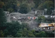  ?? (AP/Salvatore Laporta) ?? Flooded and mud-covered houses are seen after heavy rainfall triggered landslides that collapsed buildings and left as many as 12 people missing Saturday in Casamiccio­la on the southern Italian island of Ischia.