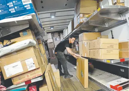  ?? Mark Lennihan, The Associated Press ?? An employee at UPS loads packages inside a truck at a company facility in New York. The job market is the tightest it has been in nearly five decades, and online shopping is still growing at a doubledigi­t rate. Businesses now need more workers at a time when fewer are available. UPS plans to have nearly 170 job fairs across the country on Oct. 19.