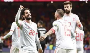  ?? AFP ?? Spain midfielder Isco (left) celebrates with Gerard Pique (right) and Sergio Ramos after scoring in their friendly with Argentina on Tuesday night.