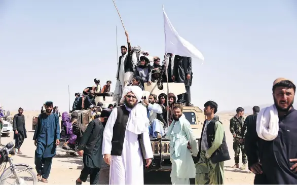  ?? JAVED TANVEER/AFP/GETTY IMAGES ?? Taliban and Afghan security forces celebrated a historic Eid ceasefire in June in Kandahar, a signal fighters on both sides are fed up with the conflict.