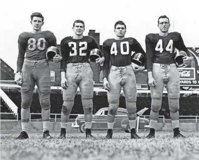  ?? THE COMMERCIAL APPEAL FILES ?? From left, members of the All-Memphis backfield on Nov. 25, 1951, are Johnny Martin (80) of Central, and Clifton Parker (32), Ralph Robison (40) and Marvin Throneberr­y (44), all of South Side.