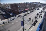  ?? (AP/Brittainy Newman) ?? Viewed from a roof, caution tape covers the corner where pedestrian­s were struck on Monday in Bay Ridge, in the Brooklyn borough of New York.