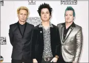  ?? FILE PHOTO BY JORDAN STRAUSS — INVISION — AP ?? Mike Dirnt, from left, Billie Joe Armstrong and Tre Cool of Green Day arrive at the American Music Awards.