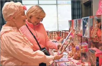  ?? Janet Baltzer ?? Spires Sunshiners Judy Guard and Roz Simpson admire the 2023 Down Syndrome Barbie.