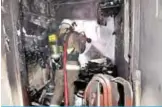  ??  ?? KUWAIT: A firefighte­r tackles a blaze inside a Salmiya building yesterday.