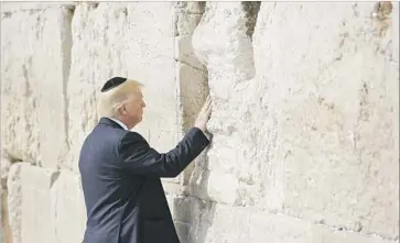  ?? Ronen Zvulun Pool Photo ?? PRESIDENT TRUMP at the Western Wall in Jerusalem. On his arrival in Tel Aviv, Trump told Israeli officials he had “found new reasons for hope” in talks with leaders of Saudi Arabia and other Arab gulf nations.