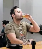  ??  ?? Hotan Mazrouee sips on a beer at the Brewers Union taproom, 520 N Meridian Ave., while wearing an Angry Scotsman t-shirt.