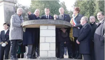  ?? — AFP ?? French President Emmanuel Macron (C) listens to the Mayor of Les Eparges Xavier Pierson (2ndl) next to writer Michel Bernard as they visit the Point X monument in Les Eparges, eastern France, on Tuesday.