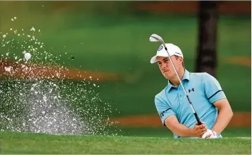  ?? CURTIS COMPTON/CURTIS.COMPTON@AJC.COM ?? Jordan Spieth hits out of the bunker on No. 7 during the second round of the Masters on Friday at Augusta National. He shot a 4-under 68 to move into contention, two shots behind Justin Rose.