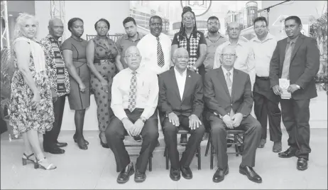  ??  ?? President David Granger (seated at centre), with Banks DIH Chairman Clifford Reis (seated at right) and Banks DIH Human Resources Director Paul Carto (seated left) with awardees (Ministry of the Presidency photo)