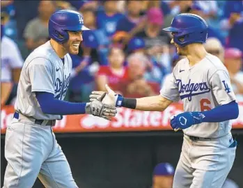  ?? Alex Gallardo Associated Press ?? FREDDIE FREEMAN, left, and Trea Turner have helped power the Dodgers to a 10-game division lead on San Diego. The club has shown depth and versatilit­y. Said Turner, “We can do a lot of different things.”