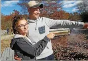  ?? MID-HUDSON NEWS NETWORK PHOTO ?? Julia Prowf gives Cullen Malzo a hug on Friday as they point to the place in Lake Mahopac where Malzo, 19, pulled Prowf, 17, and another girl from an overturned car.