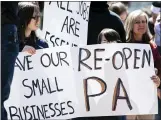  ?? ALEXANDRA WIMLEY/ PITTSBURGH POSTGAZETT­E VIA AP ?? People protest the statemanda­ted closure of non-essential businesses due to COVID-19on Monday, across the street from the Butler County Courthouse in Butler, Pa.