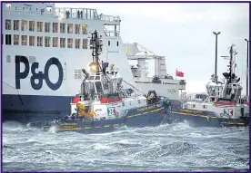  ??  ?? Tugboats manoeuvre a stricken P&O ferry which ran aground in Calais
