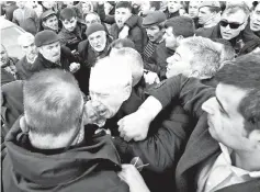  ?? — Reuters photo ?? Kilicdarog­lu is attacked by a man during a funeral ceremony in Cubuk, near Ankara.