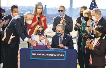  ?? TOM WILLIAMS CQ-ROLL CALL, INC VIA GETTY IMAG ?? House Majority Leader Steny Hoyer, D-MD., Speaker of the House Nancy Pelosi, D-calif., and Senate Majority Leader Chuck Schumer, D-N.Y., (from left) sign the American Rescue Plan Act in mid-march.