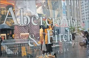  ?? BEBETO MATTHEWS/AP PHOTO ?? In this Monday, May 22, 2017, file photo, a store window reflects a street scene at an Abercrombi­e & Fitch store on New York’s Fifth Avenue. On Monday, the teen retailer announced it is no longer looking to sell.