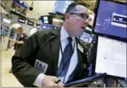  ?? RICHARD DREW — THE ASSOCIATED PRESS ?? Trader Edward Curran works on the floor of the New York Stock Exchange Monday.