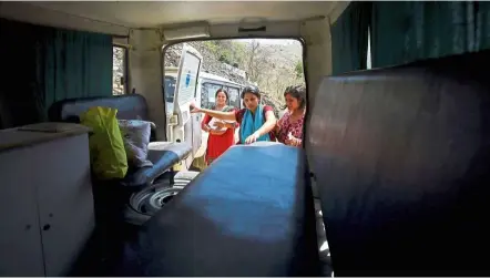  ??  ?? Nepali mother Pabitra Dhungel gets into an ambulance for her free ride home after delivering her baby at a health centre; it’s a service that has lessened the risks of childbirth for mothers in rural Nepal.