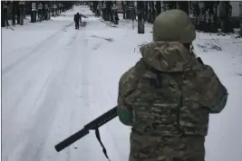  ?? LIBKOS — THE ASSOCIATED PRESS ?? A Ukrainian soldier patrols a street in Bakhmut, Donetsk region, Ukraine, on Tuesday.