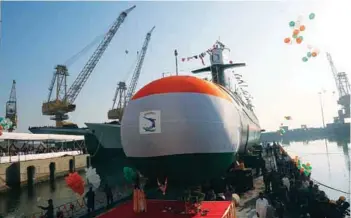  ?? PHOTOGRAPH­S: Indian Navy ?? (Top) Kalvari submarine during its sea trials; (above) Khanderi, the second of Indian Navy’s Scorpene class stealth submarine, during the launch.