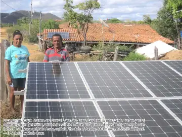  ??  ?? Local farming couple Marlene and Genival Lopes dos Santos stand next to solar panels that are part of community-shared generation, which reduces their electricit­y bill and those of their urban partners, who live in the cities of Sousa and João Pessoa, capital of the state of Paraiba, 400 km away, in Brazil’s Northeast. — IPS photos by Mario Osava