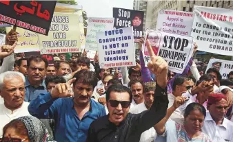  ?? AP ?? Activists of the Pakistani Hindu Council and civil society members protest in Karachi against forced conversion­s of Hindu girls to Islam and their forced marriages.