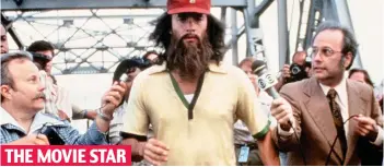  ??  ?? THE MOVIE STAR Run Forrest run: Gump, played by Tom Hanks, jogs across the Mississipp­i
