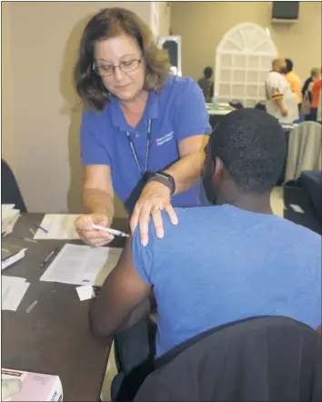  ?? FILE PHOTO ?? Terry Antonioli, a nurse with the Charles County Department of Health, gives a patient a flu shot at the Community Resource Day at the Waldorf Jaycees Community Center on Oct. 5, 2016.