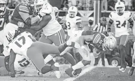  ?? MARK WALLHEISER/ AP ?? Florida State quarterbac­k Travis Jordan scores in the first half against Miami in Tallahasse­e on Saturday.