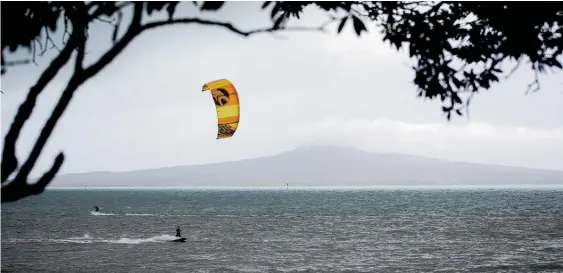  ?? Photo / Dean Purcell ?? In Auckland, kite surfers enjoyed yesterday’s challengin­g conditions.