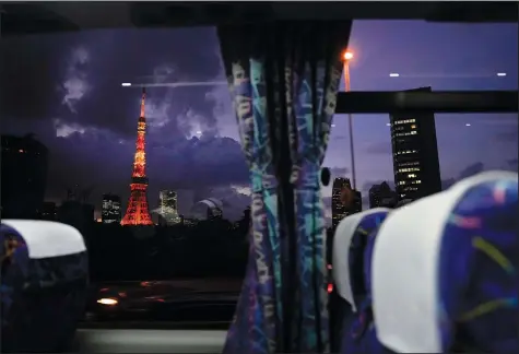  ?? (AP/Jae C. Hong) ?? The Tokyo Tower is seen through a bus window Thursday ahead of the delayed 2020 Summer Olympics in Tokyo.