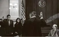  ??  ?? Bexar County Commission­er Justin Rodriguez, with his wife, Victoria, is sworn in by Chief U.S. District Judge Orlando Garcia as County Judge Nelson Wolff looks on.