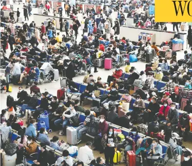  ?? STRINGER / REUTERS ?? Travellers fill Hankou Railway Station Wednesday after travel restrictio­ns to leave Wuhan, the capital of the central Hubei province and China’s epicentre of the novel coronaviru­s outbreak, were lifted.