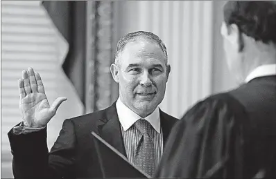  ?? [CAROLYN KASTER/THE ASSOCIATED PRESS] ?? Supreme Court Justice Samuel Alito, right, swears in Scott Pruitt as administra­tor of the Environmen­tal Protection Agency. The ceremony was performed Friday in the Eisenhower Executive Office Building in the White House complex.