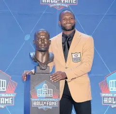  ?? USA TODAY SPORTS ?? Champ Bailey poses with his bust during the Pro Football Hall of Fame Enshrineme­nt.