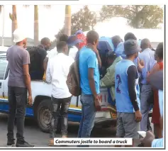  ?? ?? Commuters jostle to board a truck