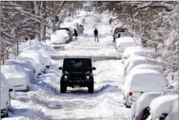  ?? DAVID ZALUBOWSKI / AP ?? A sports-utility vehicle navigates an icy road in Denver on March 15 after a storm dumped around 60 centimeter­s of snow on the Colorado capital. Tens of thousands of people across the US Rockies were left without power and flights were grounded at Denver’s airport as the region dug out from one of the most powerful late-winter blizzards in two decades. The airport reopened late on March 15.