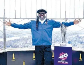  ?? COURTESY OF ICC-CRICKET ?? Chris Gayle displays the ICC Men’s T20 World Cup Trophy atop the Empire State Building in New York.